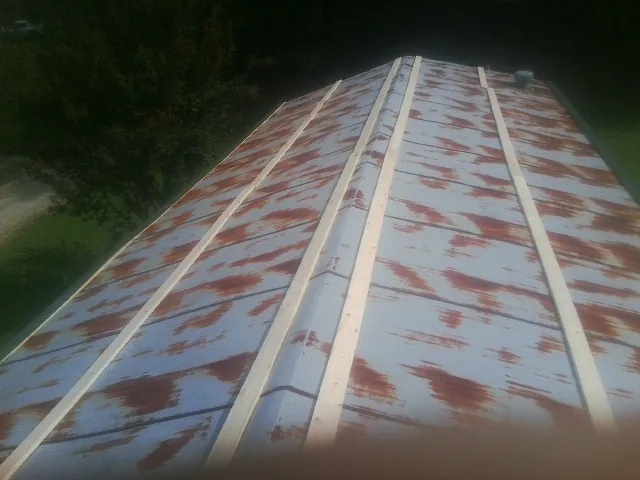 Rusted metal roof panels with new wood purlins before replacement — Storm Damage Roof Repair in Telford by Roofing Brothers