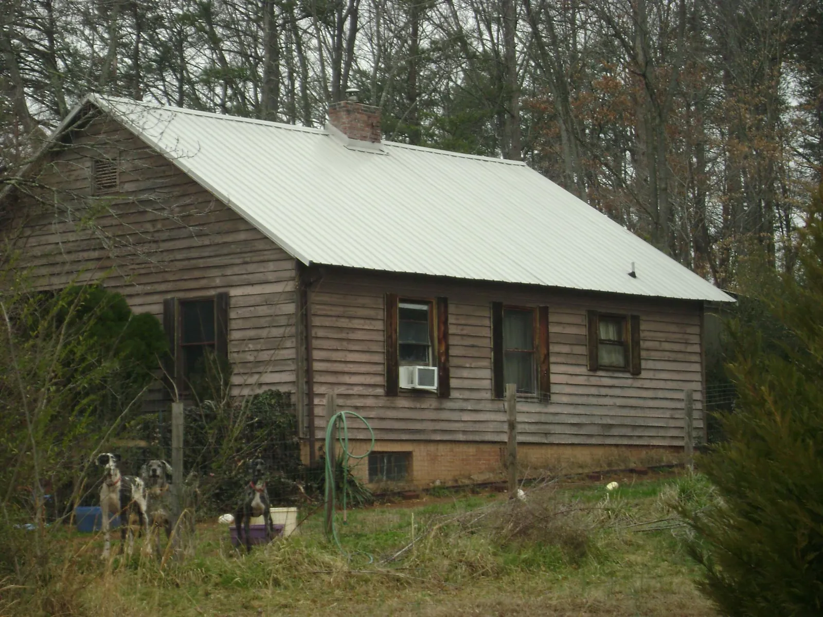White metal roof on an old wood sided farmhouse, from a Metal Roof Installation job in Telford
